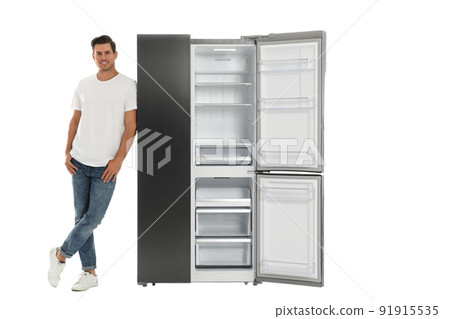 Man near open empty refrigerator on white background Man near open empty refrigerator on white background 91915535