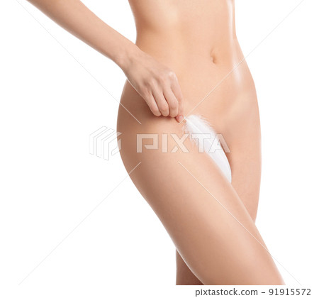 Woman with leaf showing smooth skin after Brazilian bikini epilation on pink background, closeup Woman with leaf showing smooth skin after Brazilian bikini epilation on pink background, closeup 91915572