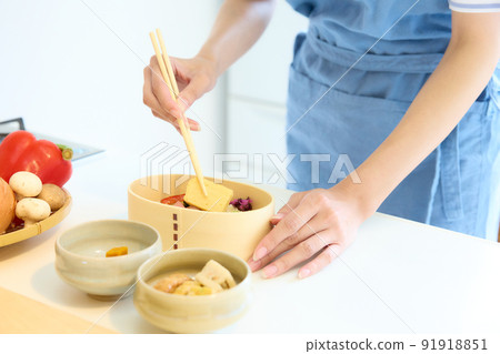 A woman making a lunch box A woman making a lunch box 91918851