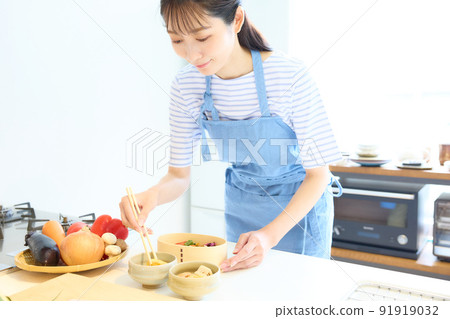 A woman making a lunch box 91919032