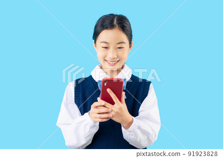 Female student looking at a smartphone Female student looking at a smartphone 91923828