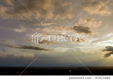 At sunset, storm clouds create a dramatic panorama At sunset, storm clouds create a dramatic panorama 91923860