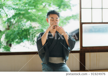 Japanese man with a beard drinking tea 91924976