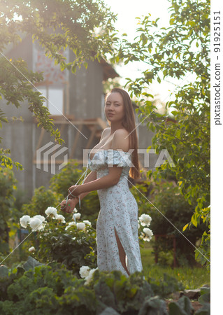 Sensual woman standing in garden Sensual woman standing in garden 91925151