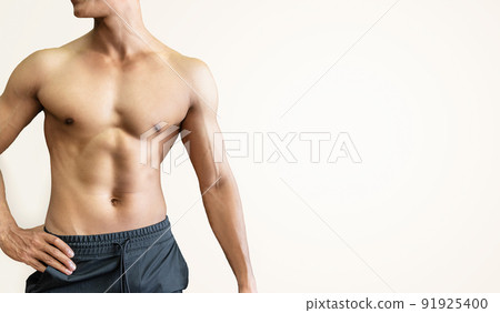 Handsome muscular man posing and flexing muscles on white background. Handsome muscular man posing and flexing muscles on white background. 91925400