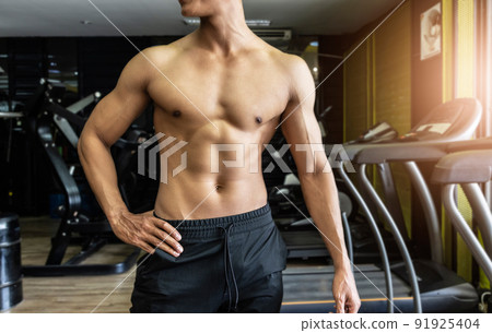Handsome muscular man posing and flexing muscles. Handsome muscular man posing and flexing muscles. 91925404