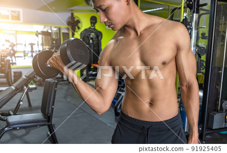 Handsome muscular man posing and flexing muscles. Handsome muscular man posing and flexing muscles. 91925405