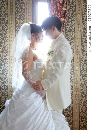 Bride in a wedding dress and groom in white black tie Photo Wedding studio photo, in front of bridal photo 91927292