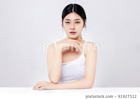 Beautiful young Asian woman with clean fresh skin on white background. Beautiful young Asian woman with clean fresh skin on white background. 91927312