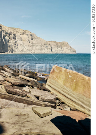 The sea and rocks on the south coast. Crimea, a landscape on a sunny day. Front view. 91927330