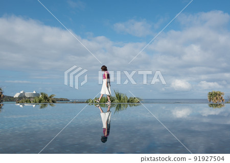 Reflection and women in the garden of Hyatt Regency in Serakaki, Onna-mura, Kunigami-gun, Okinawa Reflection and women in the garden of Hyatt Regency in Serakaki, Onna-mura, Kunigami-gun, Okinawa 91927504
