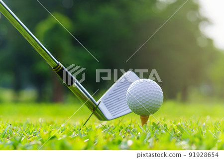 Man Golfer Hitting Ball with Club on Beatuiful Golf Course Man Golfer Hitting Ball with Club on Beatuiful Golf Course 91928654