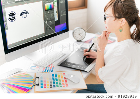 A woman thinking about logo design on a personal computer (pen tab) (creative idea) A woman thinking about logo design on a personal computer (pen tab) (creative idea) 91928919