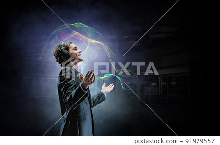 Young businessman with headphones . Mixed media 91929557
