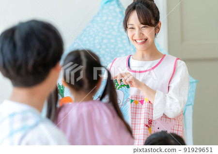 Nursery teacher playing picture-story show 91929651