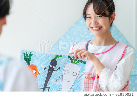 Nursery teacher playing picture-story show 91930021