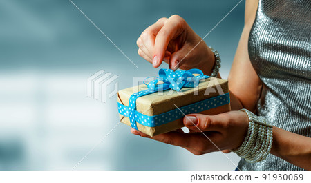 Closeup hands giving surprise gift box Closeup hands giving surprise gift box 91930069