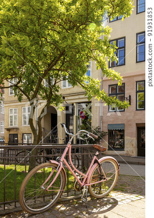 Vintage pink bicycle in Copenhagen city, Denmark 91931853
