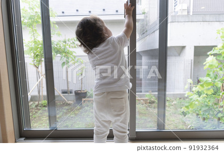 Baby trying to remove the windowpane crescent 91932364