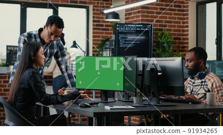 Two software developers analyzing source code looking at green screen chroma key mockup with coworker sitting at desk writing algorithm. Software developers working on artificial intelligence project. Two software developers analyzing source code looking at green screen chroma key mockup with coworker sitting at desk writing algorithm. Software developers working on artificial intelligence project. 91934265