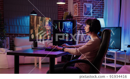 Woman playing online action game angry after losing online competition on gaming pc at home. Gamer girl unhappy and disappointed after failing level in first person shooter tournament challenge. 91934416