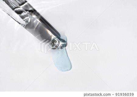 Pipette with fluid serum, oil, face gel cleaner. Cosmetics and healthcare concept closeup. Dose of retinol with air bubbles. Flat lay. Monkeypox, coronavirus research 91936039