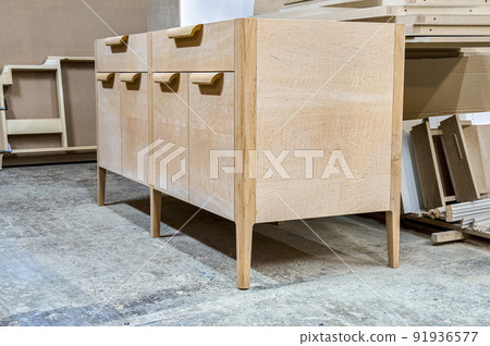 Chest of drawers made of solid alder in process of production at workshop. Creation of modern domestic furniture for bedroom interior 91936577