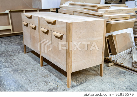 Chest of drawers made of solid alder in process of production at workshop. Creation of modern domestic furniture for bedroom interior 91936579