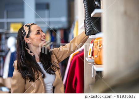 Smiling attractive young woman shopping in a store 91936632
