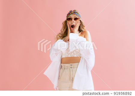Portrait of beautiful young woman posing isolated over pink studio background. Emotive. Shocked expression 91936892