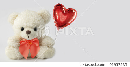 Cute teddy bear holds a heart ball. Valentine with a bear. 91937385