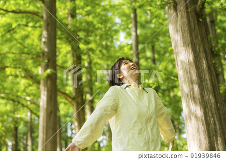 Young woman walking in the forest Young woman walking in the forest 91939846