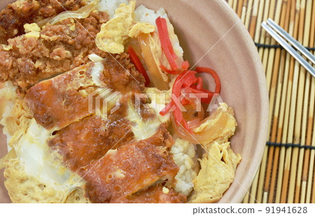 deep fried slice pork with egg or tonkatsu with Japanese pickled vegetable on rice in bowl 91941628