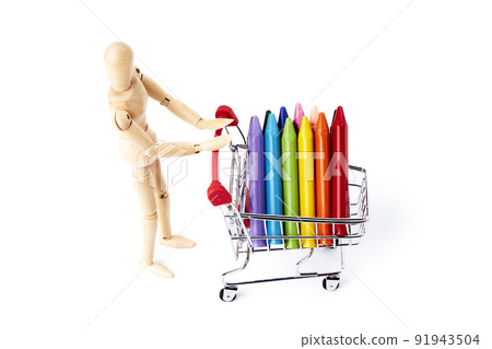 Colored crayons in a shopping cart pushed by a Dummy. Studio concept 91943504