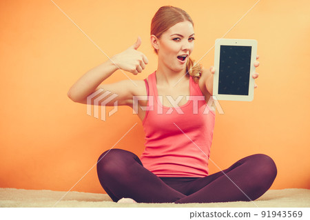 Sporty girl with pc tablet. Blank screen copyspace Sporty girl with pc tablet. Blank screen copyspace 91943569