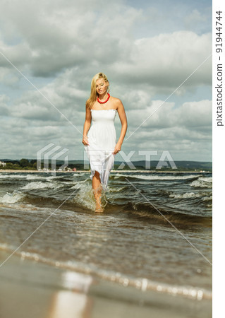 Beautiful blonde girl on beach, summertime Beautiful blonde girl on beach, summertime 91944744