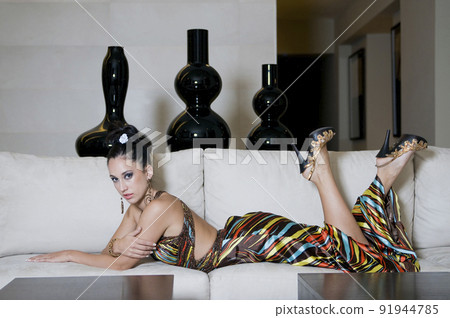 Young woman lying on sofa Young woman lying on sofa 91944785