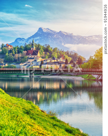 Salzburg sunset light and reflection of the city in warm lights. Austria 91944916