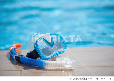 Scuba diving mask nearl swimming pool on vacation at resort. Summer sunny day 91945003