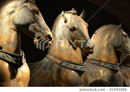 Ancient bronze horses inside Basilica di San Marco in Venice. Famous quadriga from Constantinople, monument of Byzantine art. St Mark's Basilica is top landmark of Venice Ancient bronze horses inside Basilica di San Marco in Venice. Famous quadriga from Constantinople, monument of Byzantine art. St Mark's Basilica is top landmark of Venice 91945006