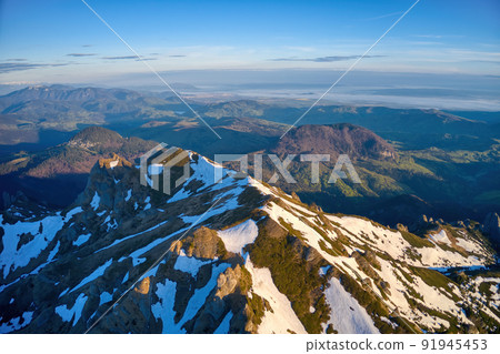 Aerial view over Ciucas Mountains, Ciucas Peak, Romania, Europe. Morning light at sunrise 91945453