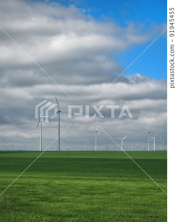 Eolian farm renewable energy in fresh green field against clear blue sky Eolian farm renewable energy in fresh green field against clear blue sky 91945455