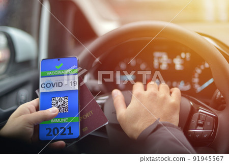 Covid-19 Health Passport. Vaccinated man holding cell phone with covid 19 vaccination proof Covid-19 Health Passport. Vaccinated man holding cell phone with covid 19 vaccination proof 91945567