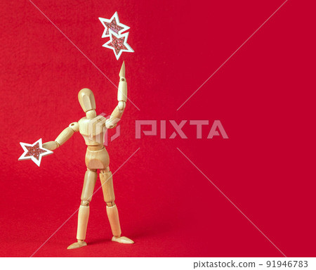 Business and design concept - wooden mannequin with stars on a red background 91946783