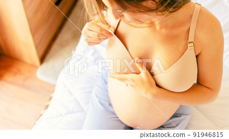 Breast health cancer pregnant woman check. Young pregnancy woman examining breast for signs lumps. Cancer self check. Healthy lifestyle medical awareness. Breast health cancer pregnant woman check. Young pregnancy woman examining breast for signs lumps. Cancer self check. Healthy lifestyle medical awareness. 91946815