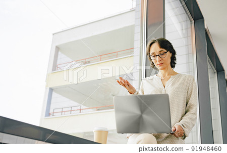 Successful Middle-aged business womanvideo call on laptop 91948460