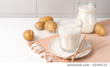 A glass of potato milk on the table. Alternative Plant-Based Milk 91949132