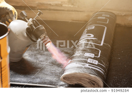 installation of waterproofing coating on the floor with a blowtorch and resin. installation of waterproofing coating on the floor with a blowtorch and resin. 91949284