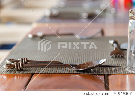Close-up of spoon on the set table Close-up of spoon on the set table 91949367
