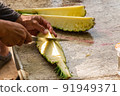 Closeup on  cutting pineapple 91949371